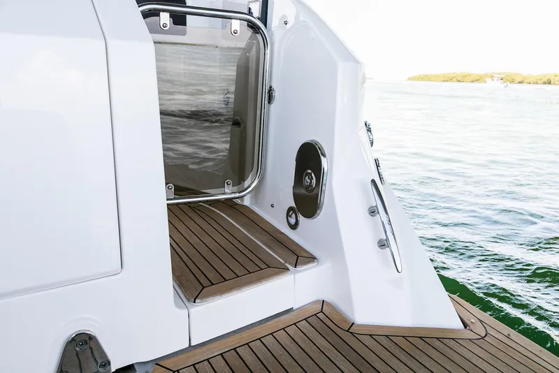 Slide: The Image of 2022 Sea Ray Sundancer 320 Outboard docked, featuring sleek design and American flag. - 2