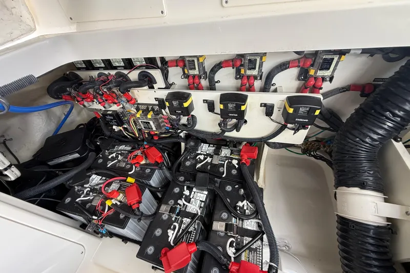 Slide: The Image of Engine compartment of 2022 Sea Ray Sundancer 320 Outboard with batteries and wiring. - 21