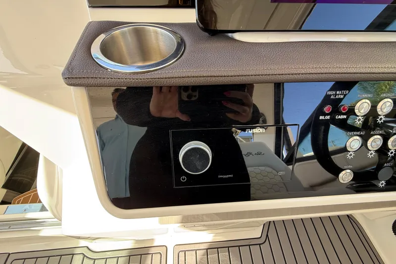 Slide: The Image of 2022 Sea Ray Sundancer 320 Outboard dashboard with controls and cup holder. - 24