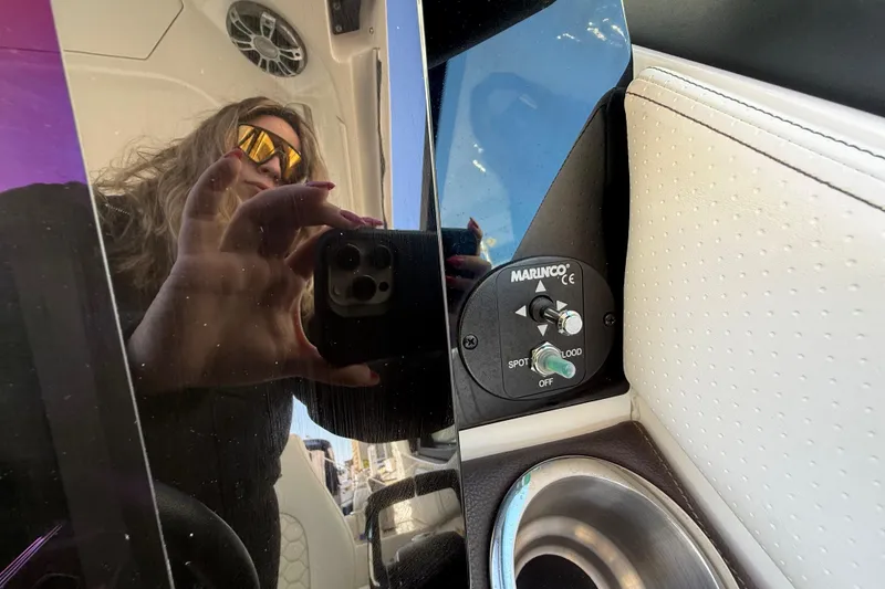 Slide: The Image of Reflection on Sea Ray Sundancer 320 Outboard 2022 interior with control panel and cup holder. - 26