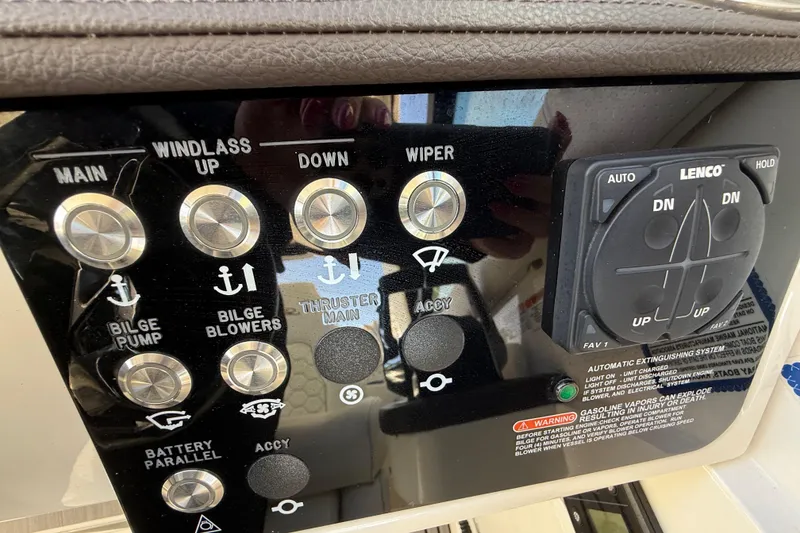 Slide: The Image of Control panel of a 2022 Sea Ray Sundancer 320 Outboard with various switches and buttons. - 28