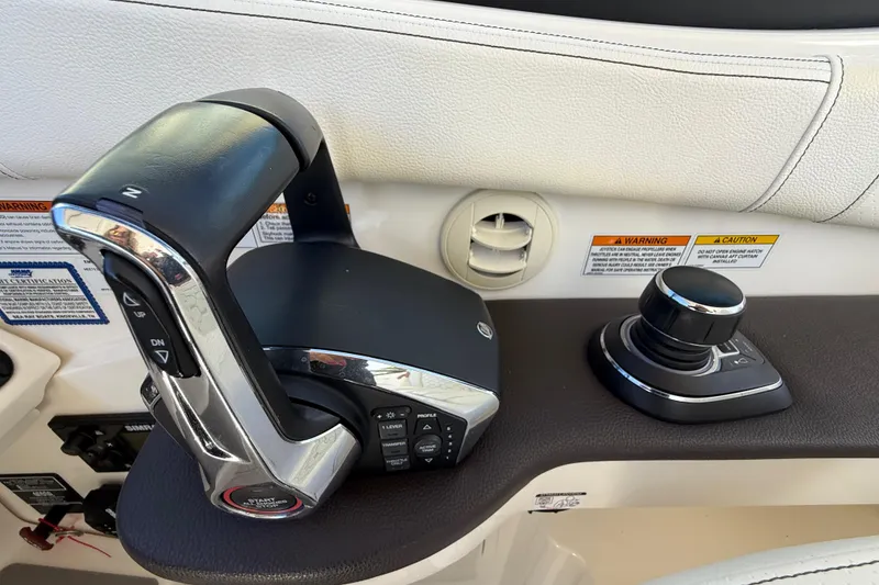 Slide: The Image of 2022 Sea Ray Sundancer 320 Outboard helm controls with joystick and throttle. - 30