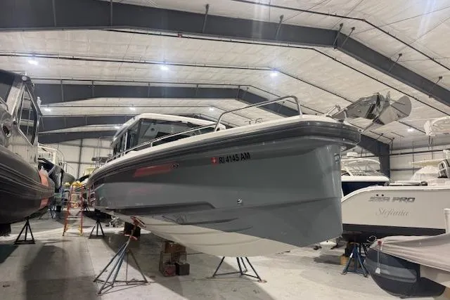 The Image of 2019 Axopar 37 XC Cross Cabin boat in indoor storage facility. - 1