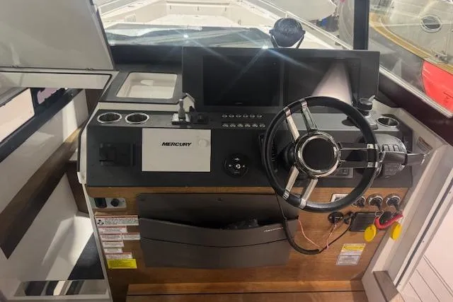 Slide: The Image of 2019 Axopar 37 XC Cross Cabin helm with steering wheel and control panel. - 12