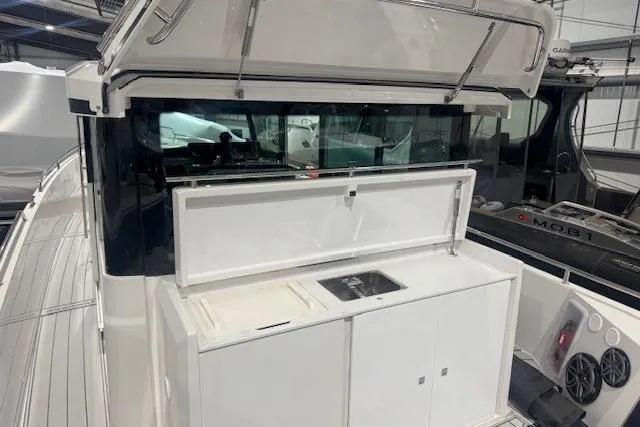 Slide: The Image of 2019 Axopar 37 XC Cross Cabin with outdoor kitchenette and sink. - 13