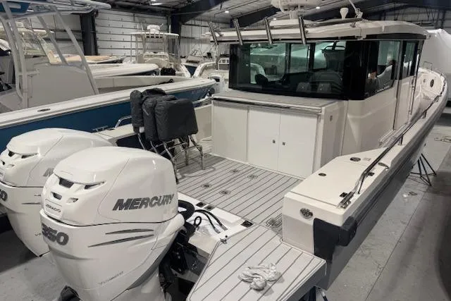 Slide: The Image of 2019 Axopar 37 XC Cross Cabin boat with twin Mercury engines in a showroom. - 3