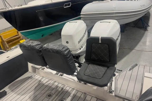 Slide: The Image of 2019 Axopar 37 XC Cross Cabin with dual Mercury outboard engines in a showroom. - 7