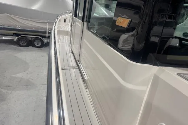 Slide: The Image of 2019 Axopar 37 XC Cross Cabin boat, side view in a showroom. - 8