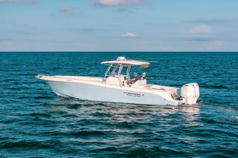 Slide: The Image of 2005 Hydra-Sports 3300 CC boat cruising on open ocean waters. - 10