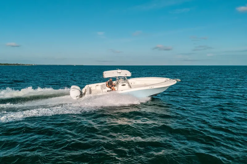 Slide: The Image of 2005 Hydra-Sports 3300 CC boat cruising on open blue ocean. - 13