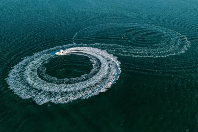 Slide: The Image of Aerial view of 2005 Hydra-Sports 3300 CC creating circular wake patterns in the ocean. - 15