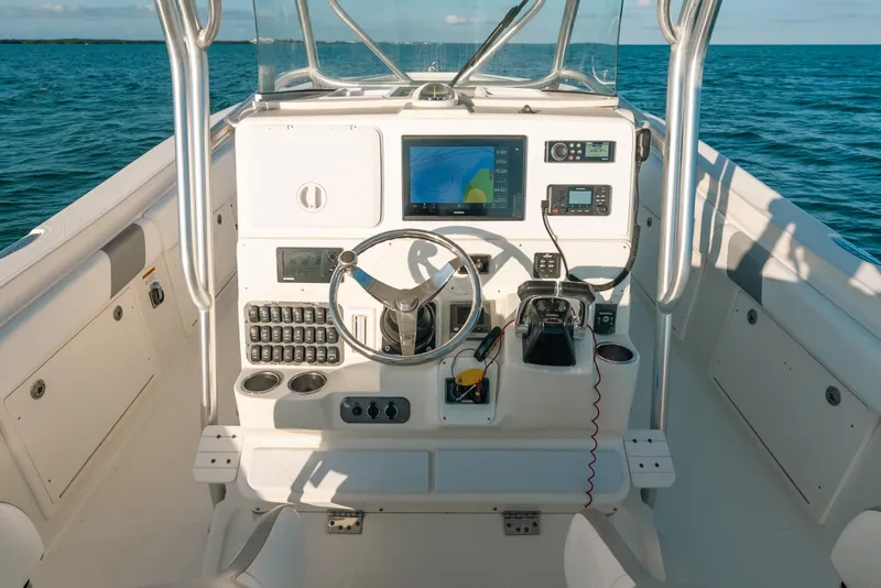 Slide: The Image of 2005 Hydra-Sports 3300 CC boat dashboard with navigation equipment on open water. - 25