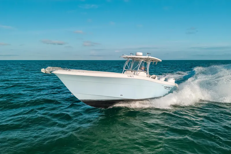 Slide: The Image of 2005 Hydra-Sports 3300 CC boat cruising on open ocean under clear blue sky. - 5