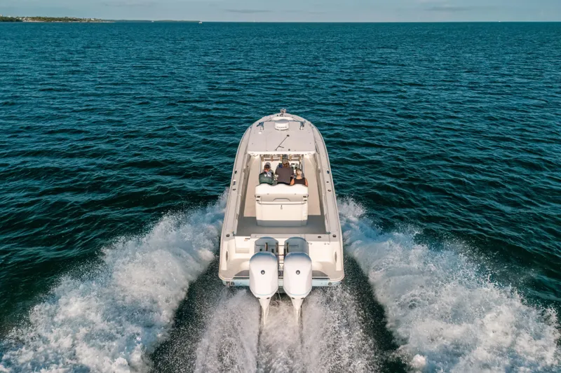 Slide: The Image of 2005 Hydra-Sports 3300 CC boat cruising on open water, rear view. - 6