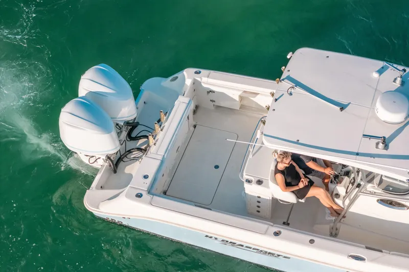 Slide: The Image of Aerial view of 2005 Hydra-Sports 3300 CC boat cruising on turquoise water. - 8