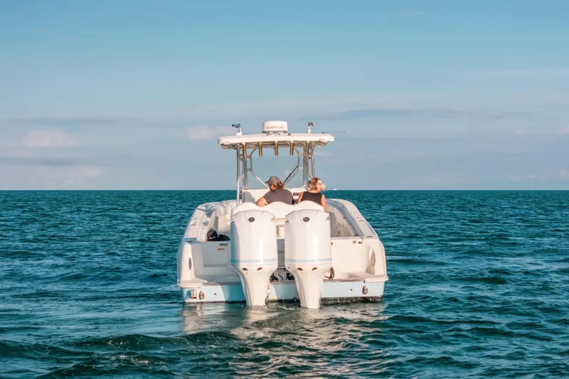 Slide: The Image of 2005 Hydra-Sports 3300 CC boat cruising on open ocean waters. - 9