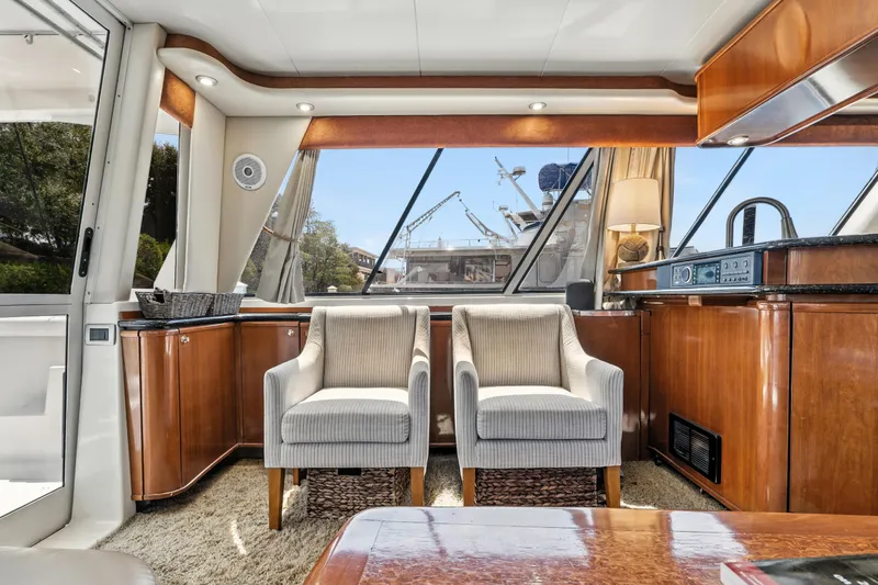 Slide: The Image of Luxurious interior of 2007 Meridian 490 Pilothouse yacht with elegant seating and wood finishes. - 11