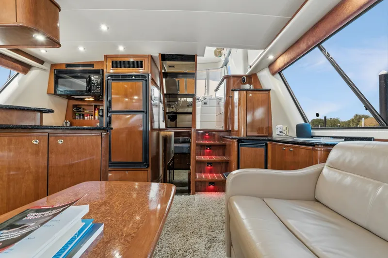 Slide: The Image of Luxurious interior of 2007 Meridian 490 Pilothouse yacht with modern kitchen and seating area. - 13