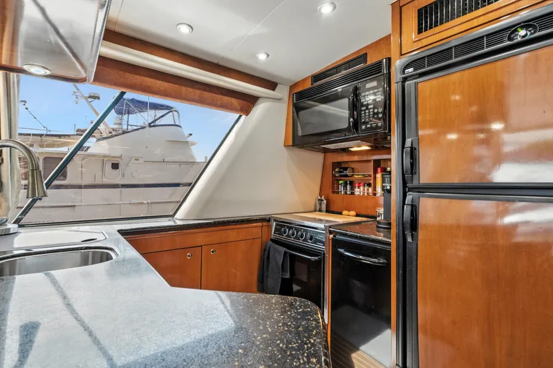 Slide: The Image of Luxurious 2007 Meridian 490 Pilothouse yacht kitchen with modern appliances and sleek design. - 16