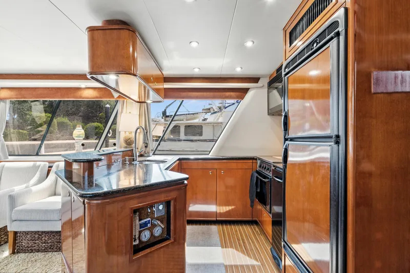 Slide: The Image of Luxurious 2007 Meridian 490 Pilothouse yacht interior with modern kitchen and elegant wood finishes. - 17
