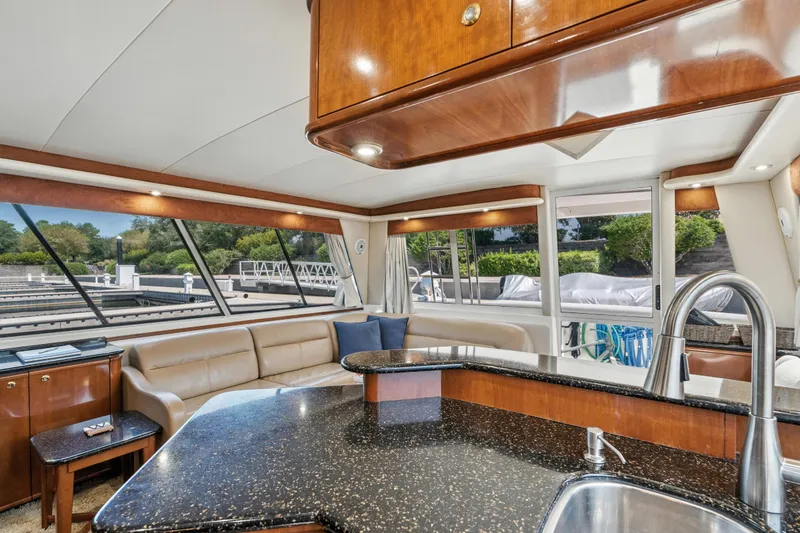 Slide: The Image of Luxurious interior of 2007 Meridian 490 Pilothouse yacht with modern kitchen and seating area. - 19