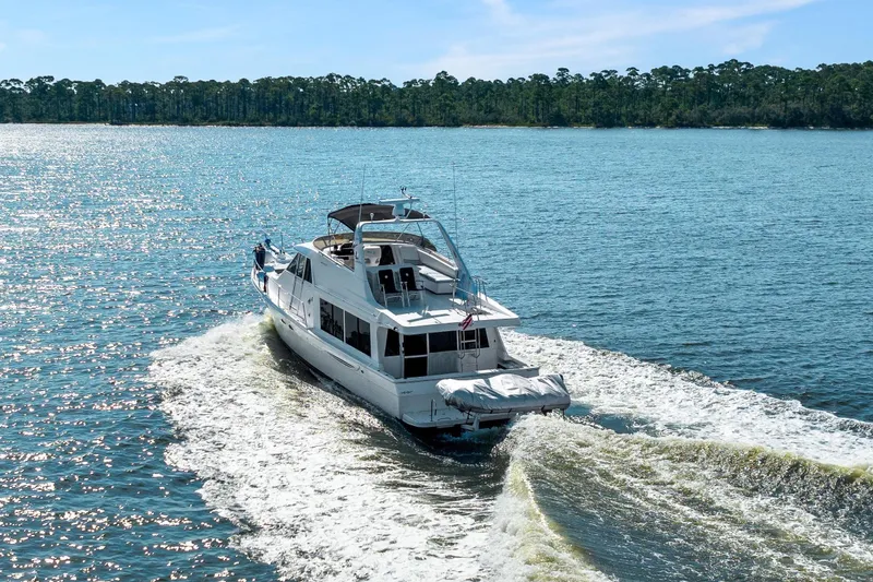 Slide: The Image of 2007 Meridian 490 Pilothouse cruising on a sunny day, leaving a wake behind. - 2