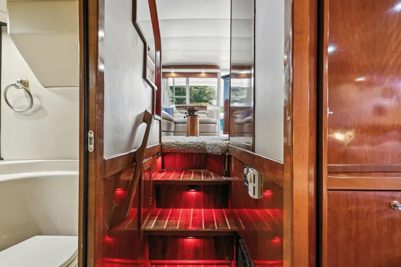Slide: The Image of Interior view of 2007 Meridian 490 Pilothouse yacht with wooden stairs and cozy seating area. - 20