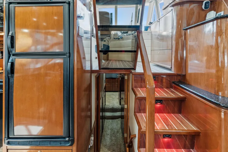 Slide: The Image of Interior of 2007 Meridian 490 Pilothouse yacht with wooden stairs and cabinetry. - 21
