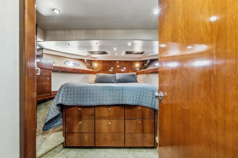 Slide: The Image of Luxurious 2007 Meridian 490 Pilothouse bedroom with wood finish and cozy bedding. - 24