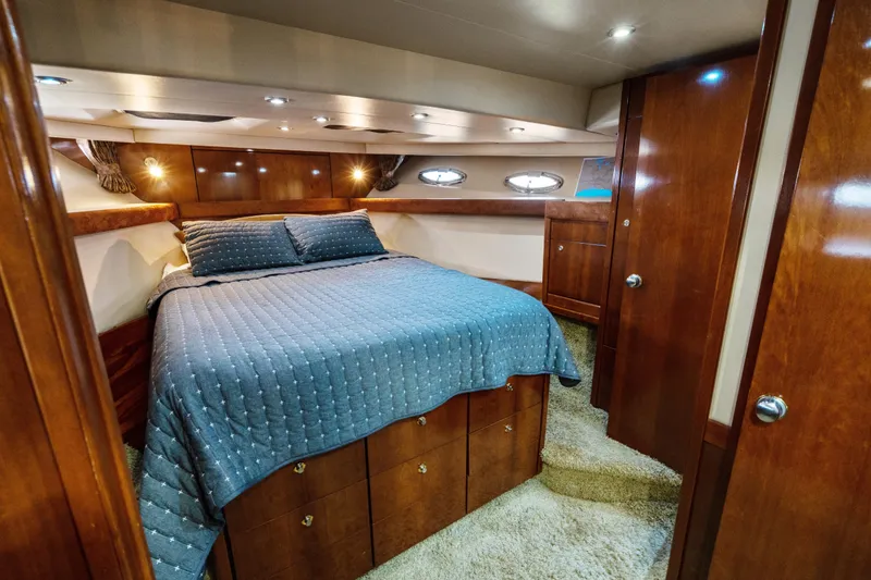 Slide: The Image of Luxurious bedroom interior of 2007 Meridian 490 Pilothouse yacht with wood finish. - 26