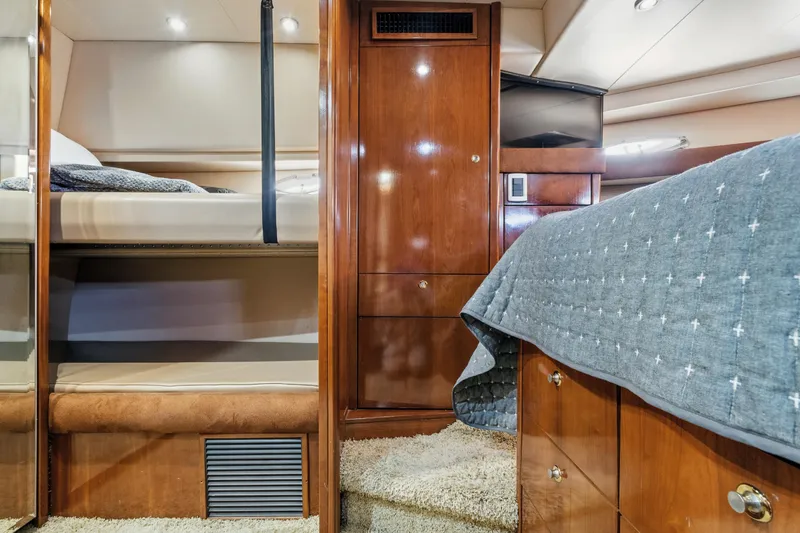 Slide: The Image of Luxurious 2007 Meridian 490 Pilothouse cabin interior with wood finishes and cozy bedding. - 28