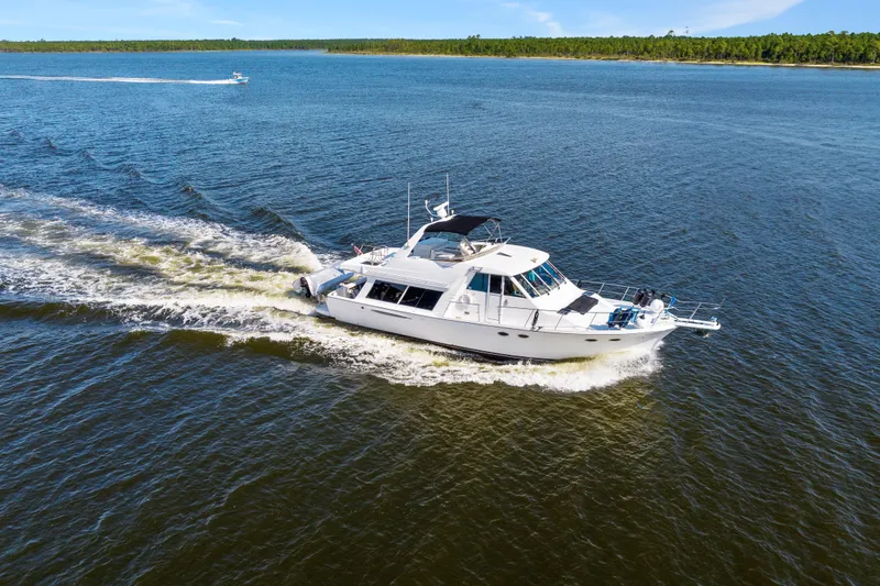 Slide: The Image of 2007 Meridian 490 Pilothouse cruising on a calm, scenic waterway. - 3