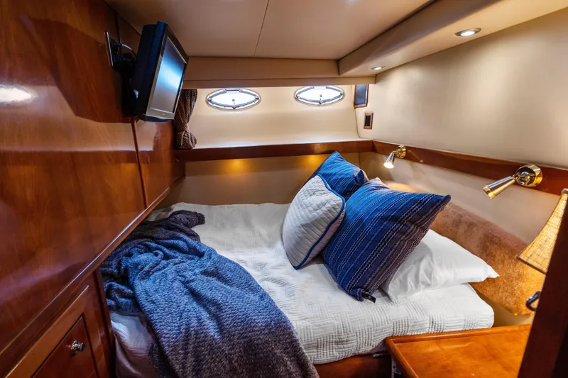 Slide: The Image of Luxurious cabin interior of 2007 Meridian 490 Pilothouse yacht with cozy bedding and ambient lighting. - 35