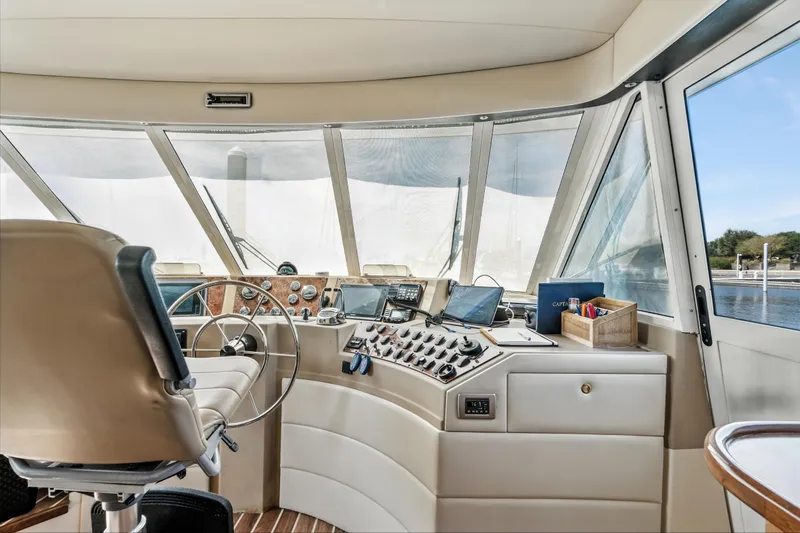 Slide: The Image of 2007 Meridian 490 Pilothouse interior with steering wheel, control panel, and navigation equipment. - 39