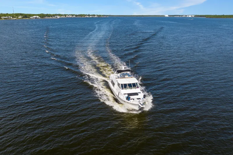 Slide: The Image of 2007 Meridian 490 Pilothouse cruising on open water under clear blue skies. - 4