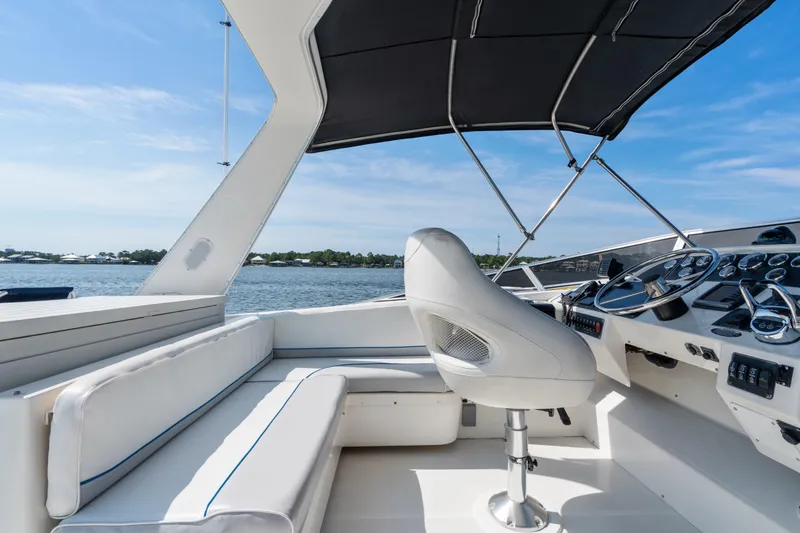 Slide: The Image of 2007 Meridian 490 Pilothouse boat interior with helm, seating, and water view. - 45