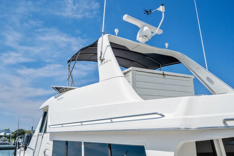 Slide: The Image of 2007 Meridian 490 Pilothouse yacht with radar, docked under clear blue sky. - 47