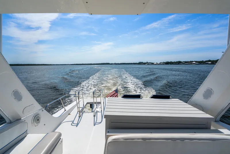 Slide: The Image of 2007 Meridian 490 Pilothouse yacht cruising on open water under a clear blue sky. - 48