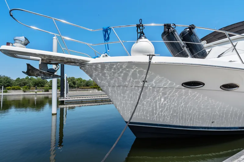 Slide: The Image of 2007 Meridian 490 Pilothouse yacht docked, reflecting sunlight on calm water. - 51