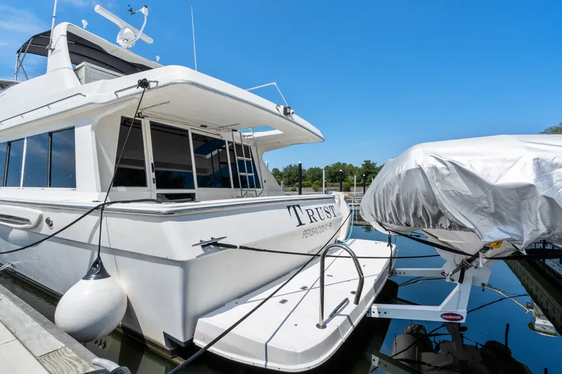 Slide: The Image of 2007 Meridian 490 Pilothouse yacht docked with covered boat nearby. - 53