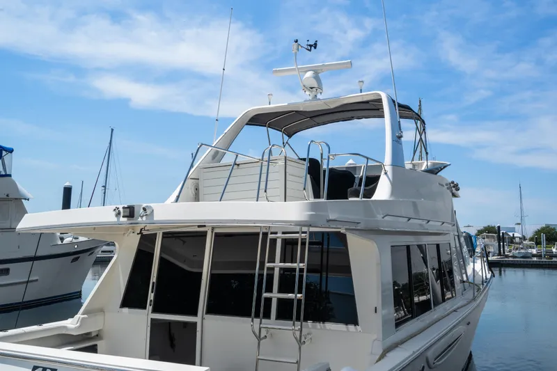 Slide: The Image of 2007 Meridian 490 Pilothouse yacht docked at marina under blue sky. - 55
