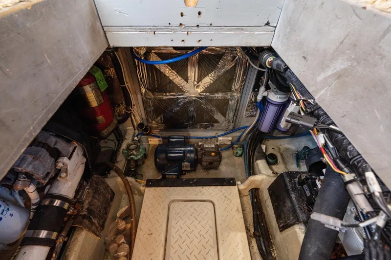 Slide: The Image of Engine room of a 2007 Meridian 490 Pilothouse with visible machinery and wiring. - 57