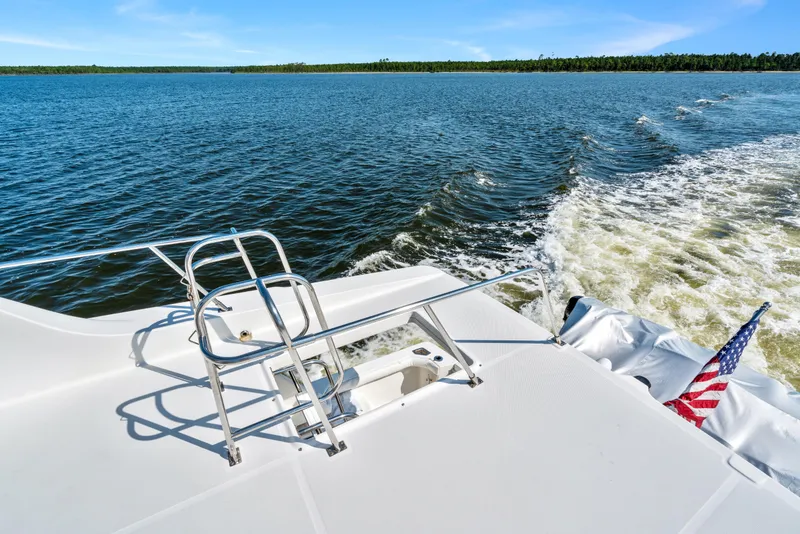 Slide: The Image of 2007 Meridian 490 Pilothouse yacht cruising on open water with American flag. - 60