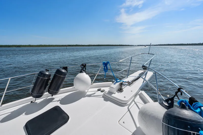 Slide: The Image of 2007 Meridian 490 Pilothouse yacht on open water under clear blue sky. - 65