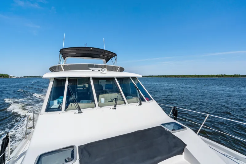 Slide: The Image of 2007 Meridian 490 Pilothouse cruising on open water under clear blue skies. - 66
