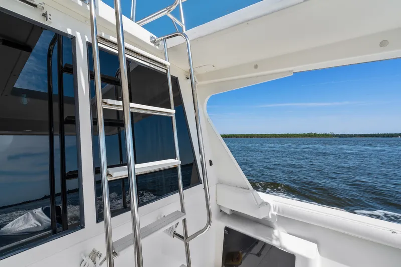 Slide: The Image of 2007 Meridian 490 Pilothouse yacht with ladder, cruising on open water. - 67