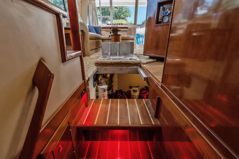 Slide: The Image of Interior view of 2007 Meridian 490 Pilothouse yacht with wooden stairs and cozy seating area. - 68