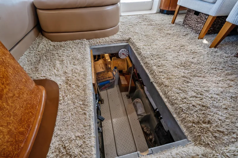 Slide: The Image of 2007 Meridian 490 Pilothouse interior with open hatch revealing storage area. - 69
