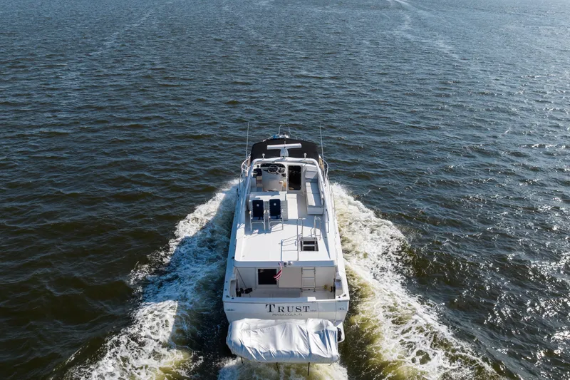 Slide: The Image of 2007 Meridian 490 Pilothouse cruising on open water, rear view. - 8