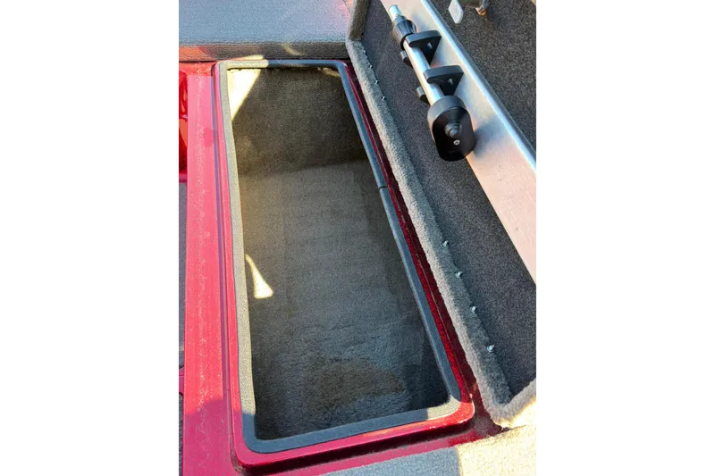 Slide: The Image of Open storage compartment in 1998 Fisher F 17 Pro boat, featuring carpeted interior. - 12